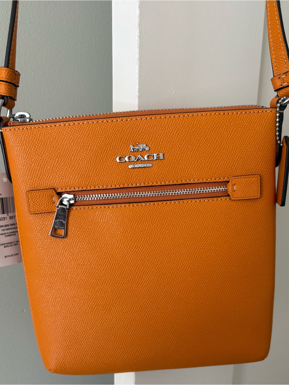 Coach Pebbled Leather Crossbody in Bright Orange with Matching wallet.